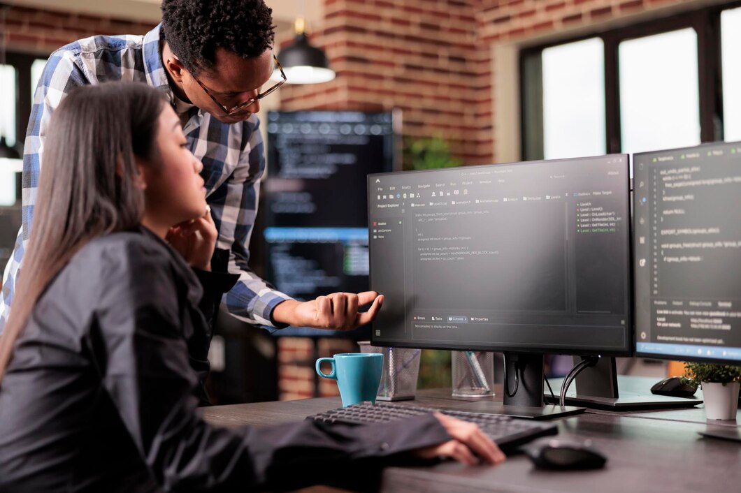 diverse-programmers-discussing-about-html-code-compiling-discovers-errors-standing-front-multiple-screens-startup-office-software-developers-working-server-interface-development